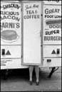 Legs poking out of hot dog van